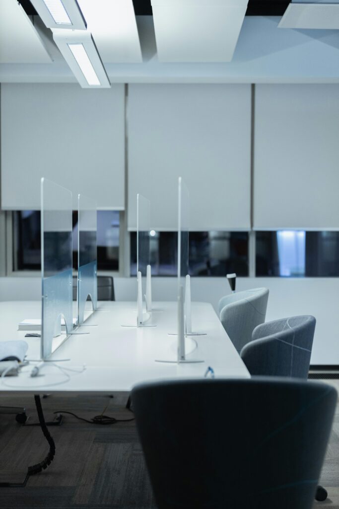 Contemporary office setting with stylish chairs and desk dividers, perfect for productivity.